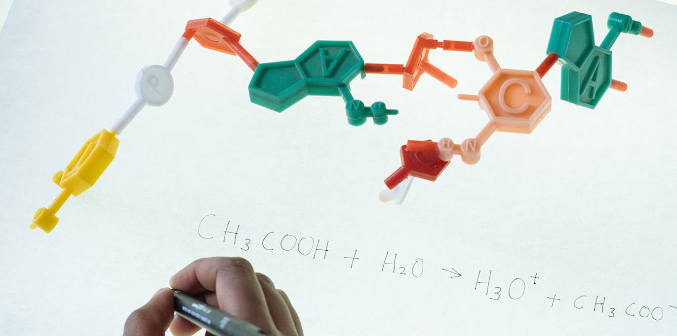 A chemical equation and molecular diagram.
