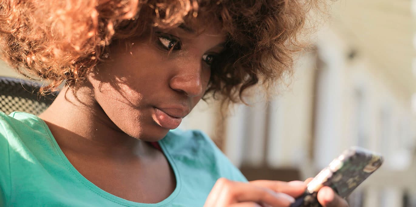 A woman looking at her phone.